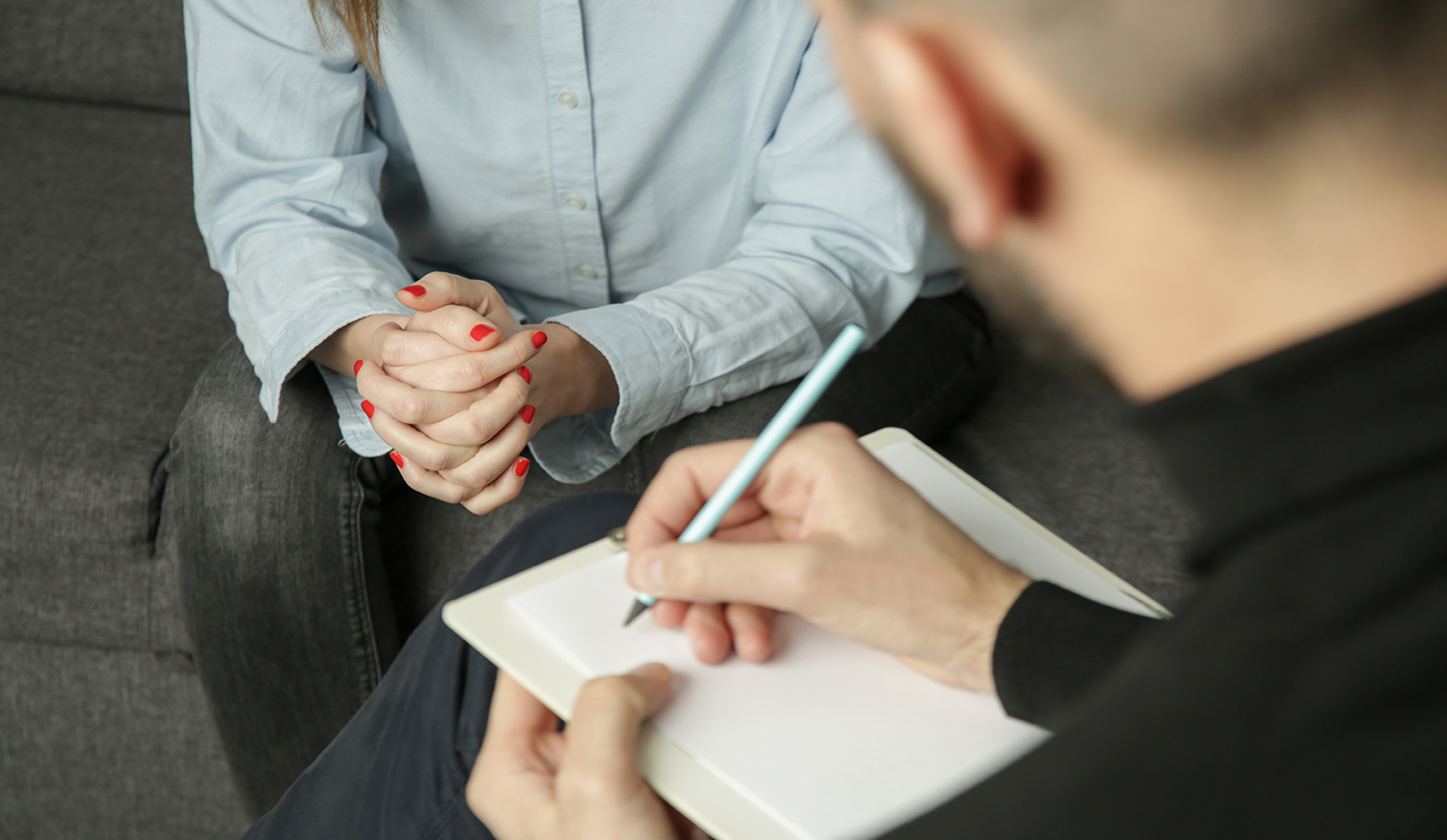 Depressed woman during psychotherapy. Young woman talking to her